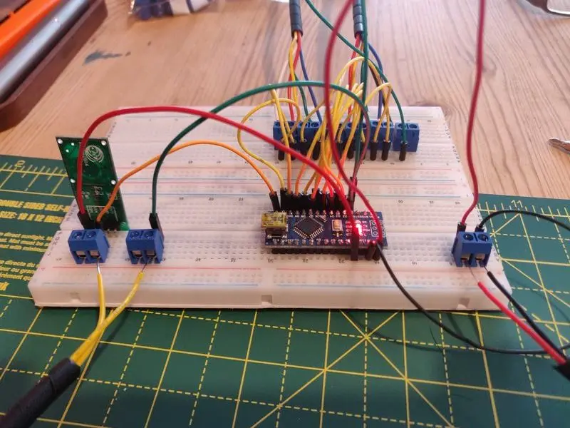 The completed Larson scanner LED board with resistors and wire in place connected to a breadboard and being tested using the Arduino and the PIR motion detector.