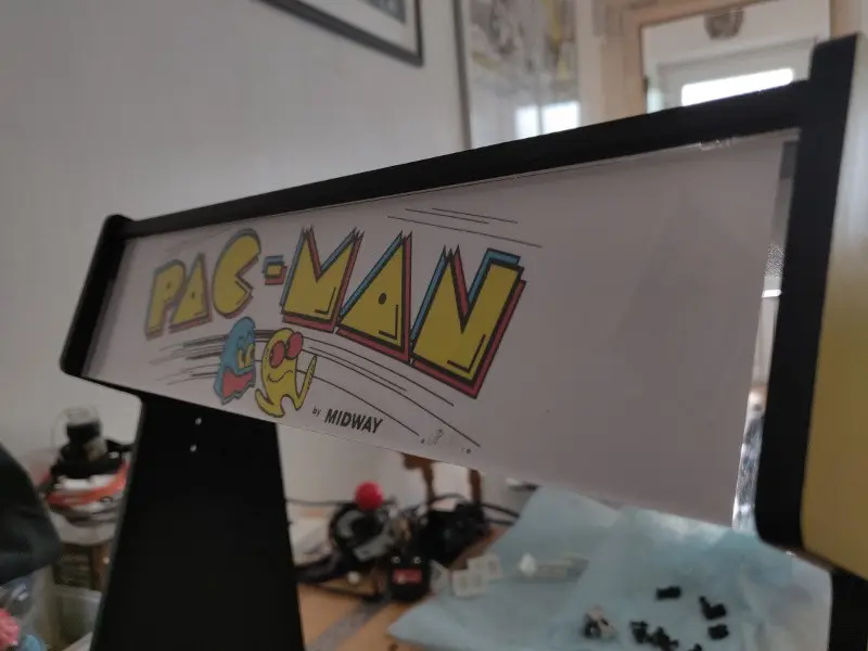 The partially reassembled Picade cabinet. The marquee along the top has been reinstalled and the Pac-Man logo has been put between the perspex sheets..