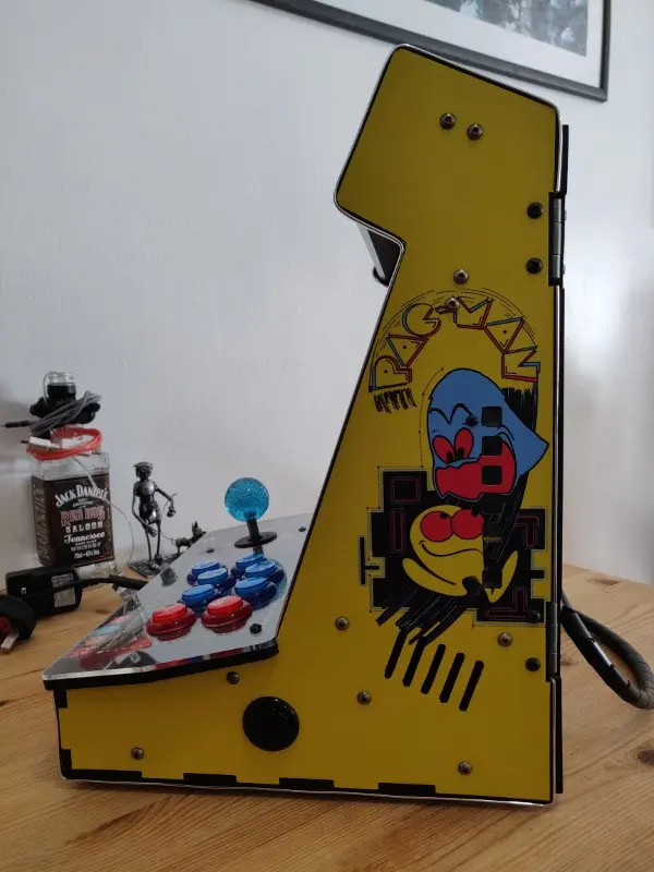 A side view of the finished cabinet, yellow Pac-Man vinyl in place.